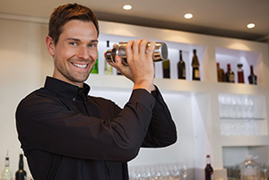 bigstock-Smiling-bartender-shaking-cock-60046682.jpg