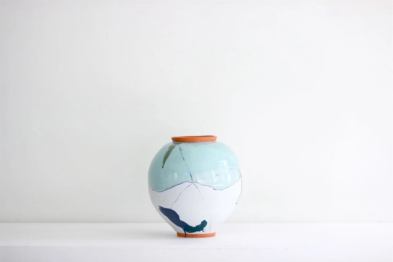 Large pot with orange rim and foot