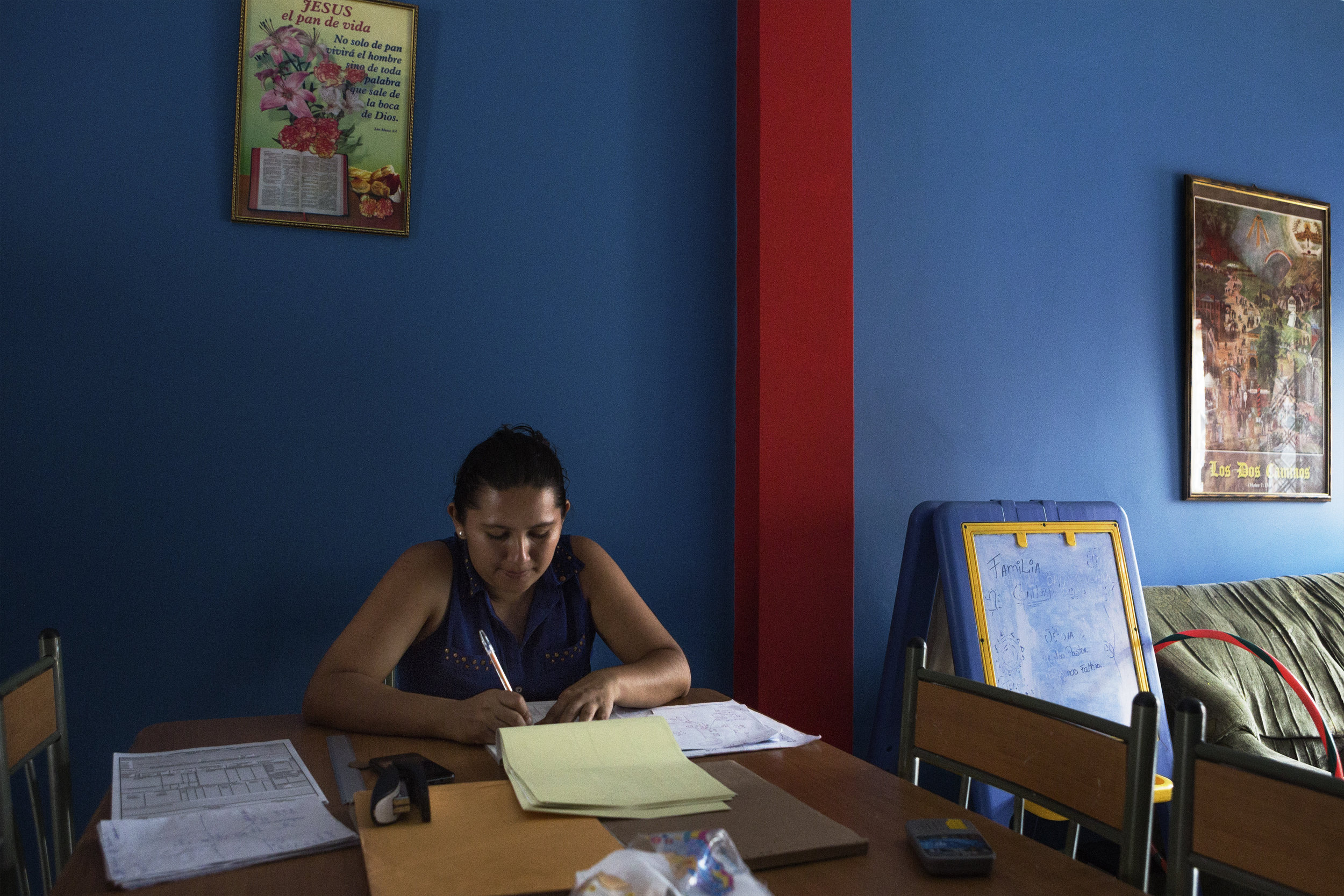 Johanna helps Ricardo with his job's paperwork. Because of the care that her Michelle's diagnosis requires, Johanna was forced to quit her previous job.