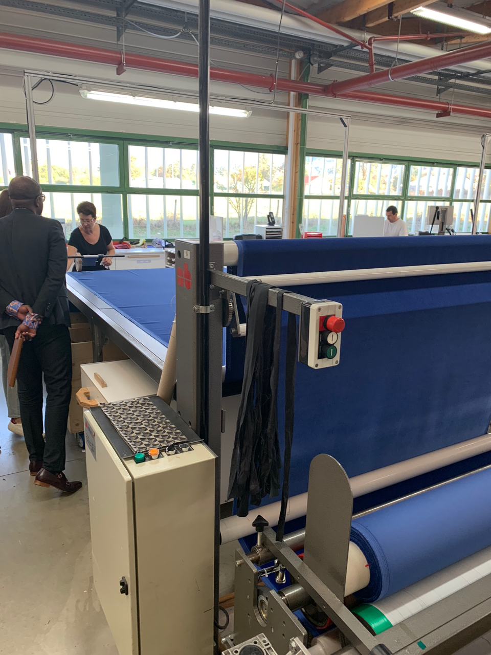 Each bolt of fabric is unrolled and hand-inspected