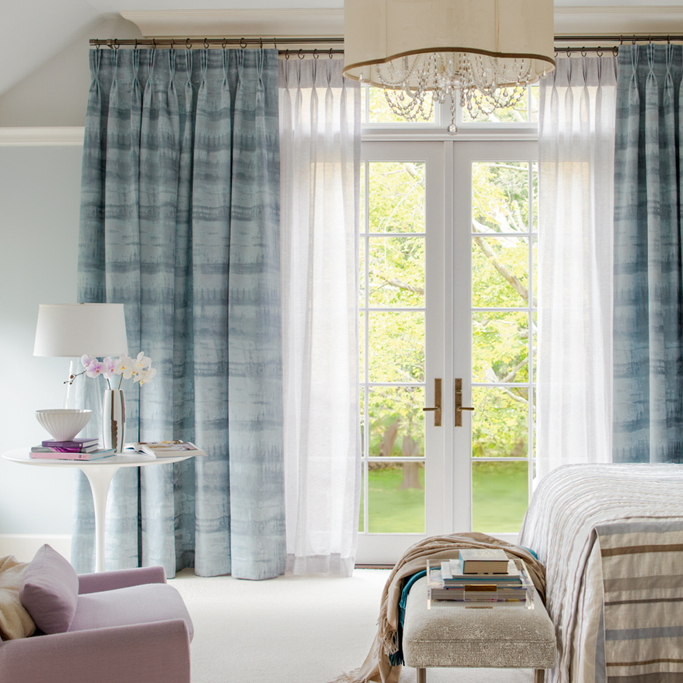 Pleated drapes over sheers