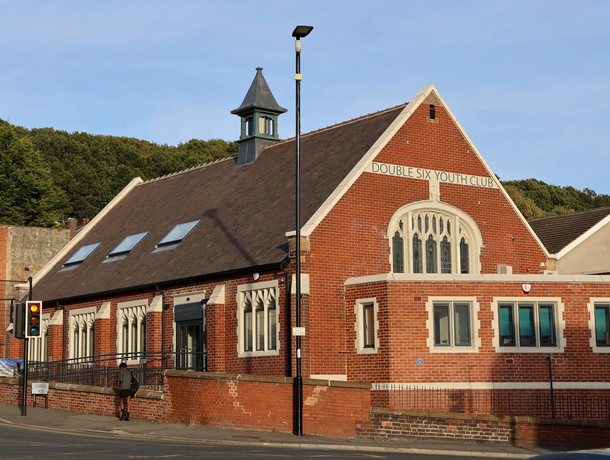 External view of Double Six Youth Club on the corner of Scarsdale Road and Chesterfield Road, showing the refurbished building envelope and feature entrance.