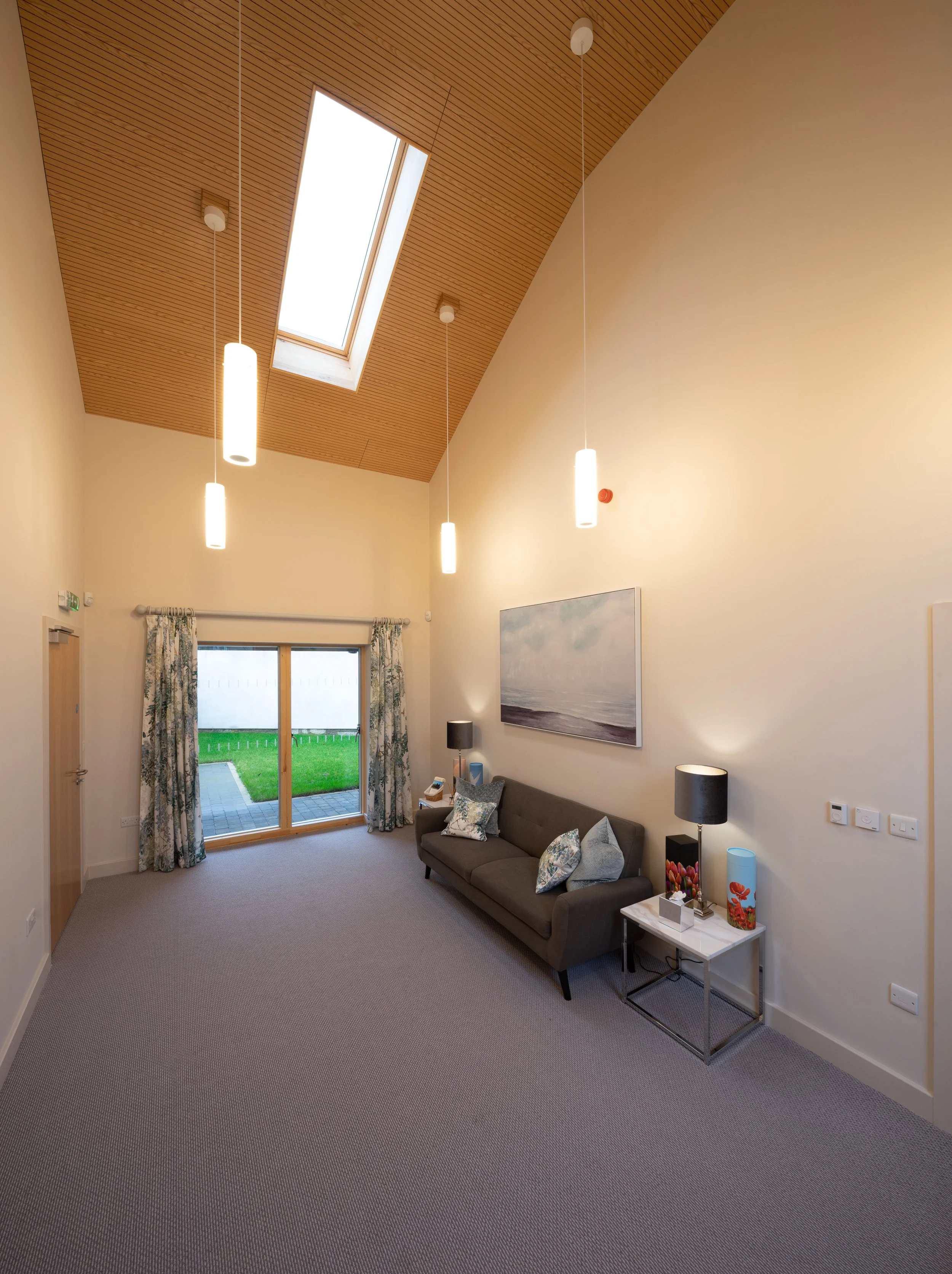 Spiritual chapel of rest interior at Belfield House Buxton featuring high-level window looking toward historic church