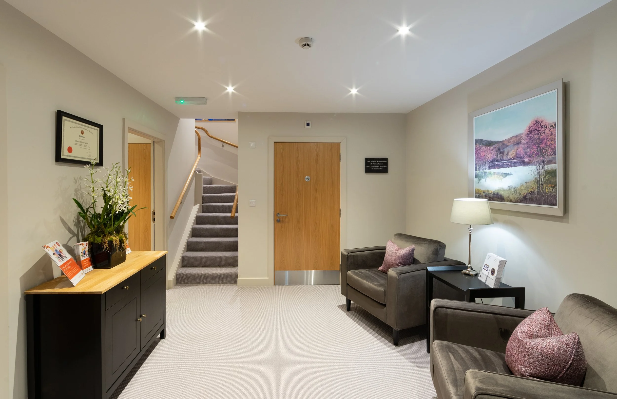 Daylit modern reception and waiting area with natural finishes at Belfield House