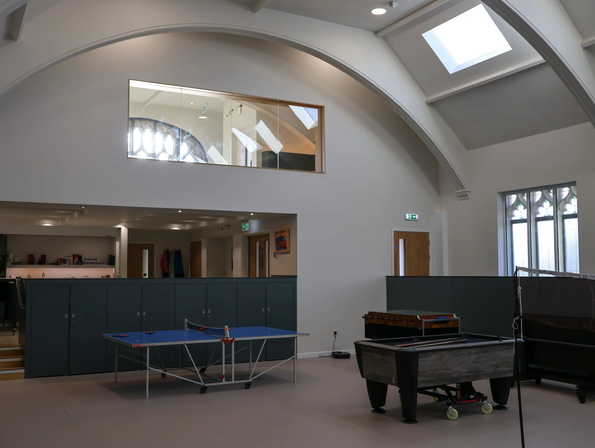 View from main hall of the first floor mezzanine and newly installed passenger lift and glazed safety balustrades for inclusive access.