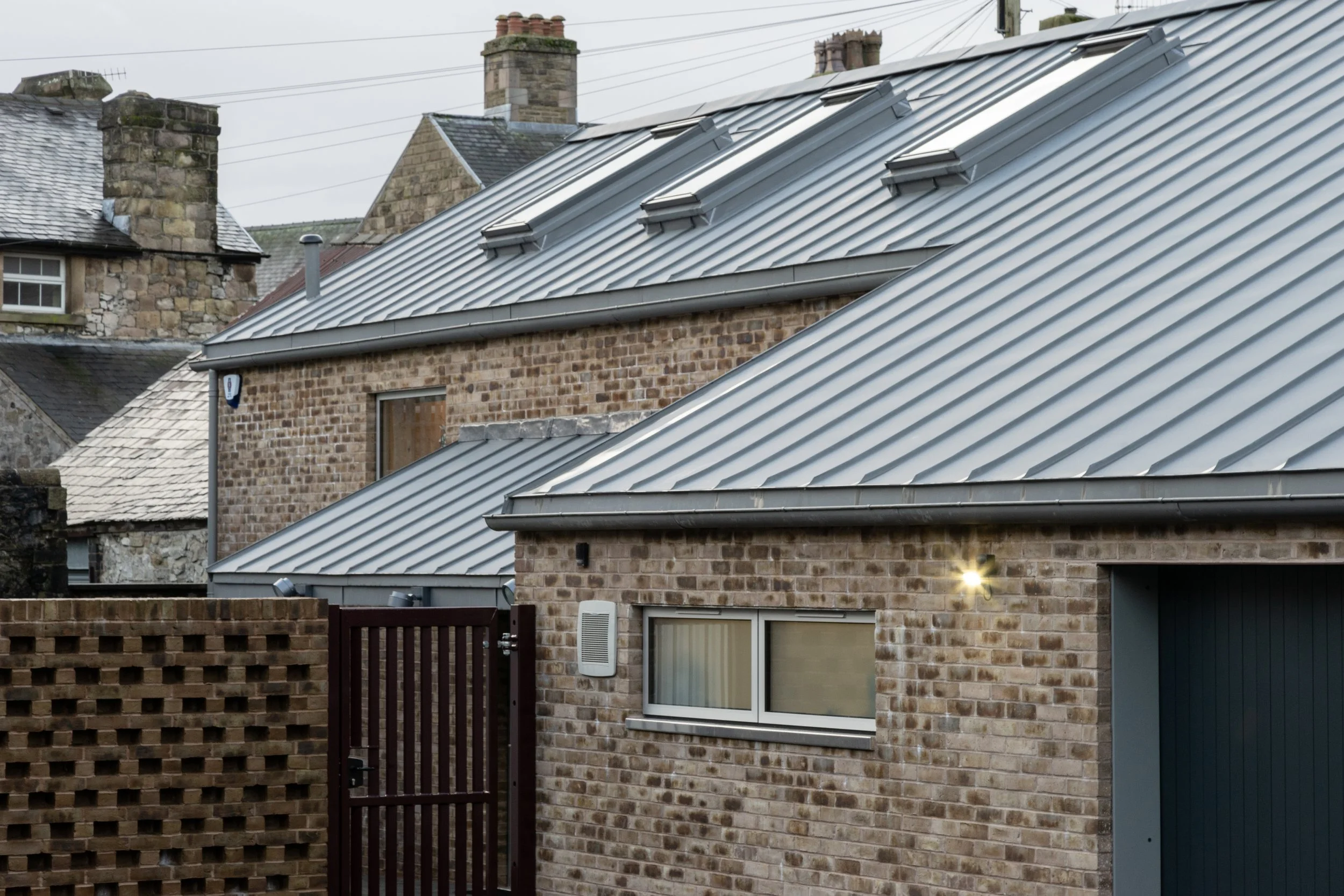 Steeply pitched quartz zinc roof profile on rear elevation of Belfield House in Derbyshire