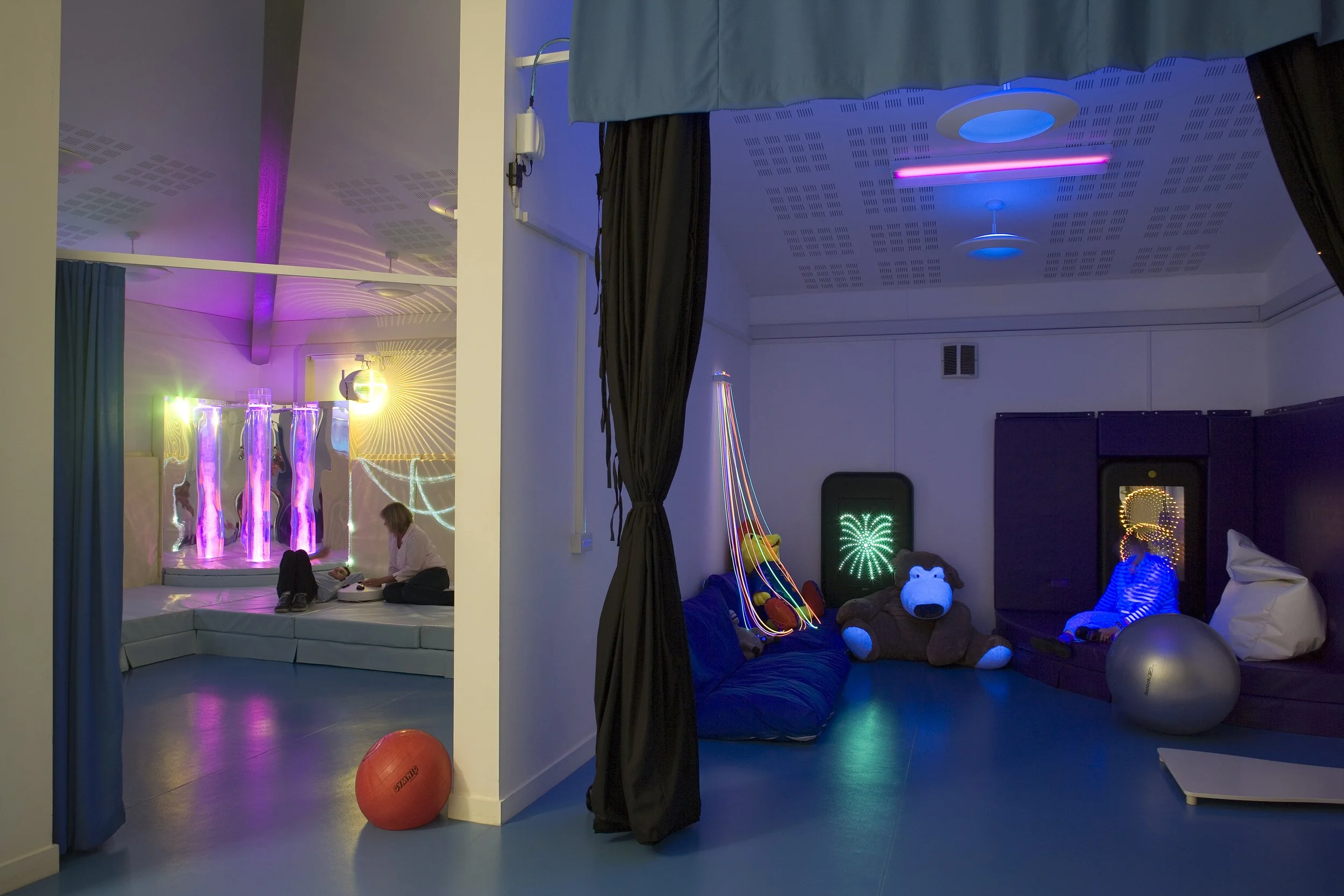 Color-coded ensory interior activity room at Brackenfield SEND Centre featuring matte oak flooring and seamless flush threshold doorways.