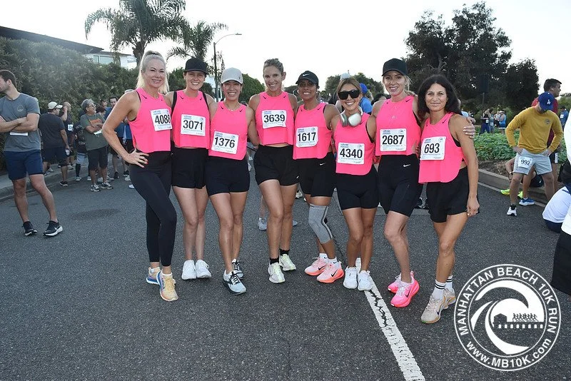 Ladies at the 2025 MB10k start wearing pink tops and black shorts/pants