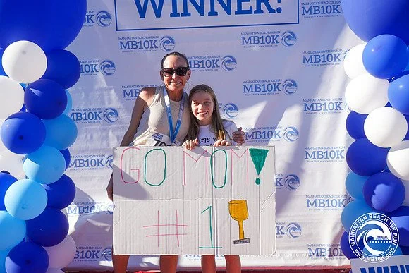 A mom and daughter at the 2026 MB10k Award stage.