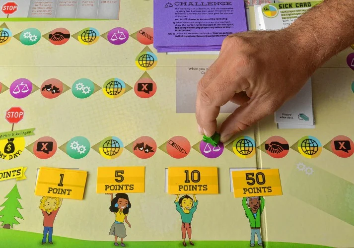 Detail of the board game, Co-opoly, made by Toolbox for Education and Social Action. Source: Daily Hampshire GAZETTE STAFF/JERREY ROBERTS 