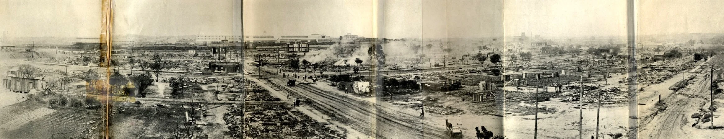 Taken from the southeast corner of the roof of Booker T. Washington High School, this panorama shows much of the damage within a day or so of the riot and the burning. Source