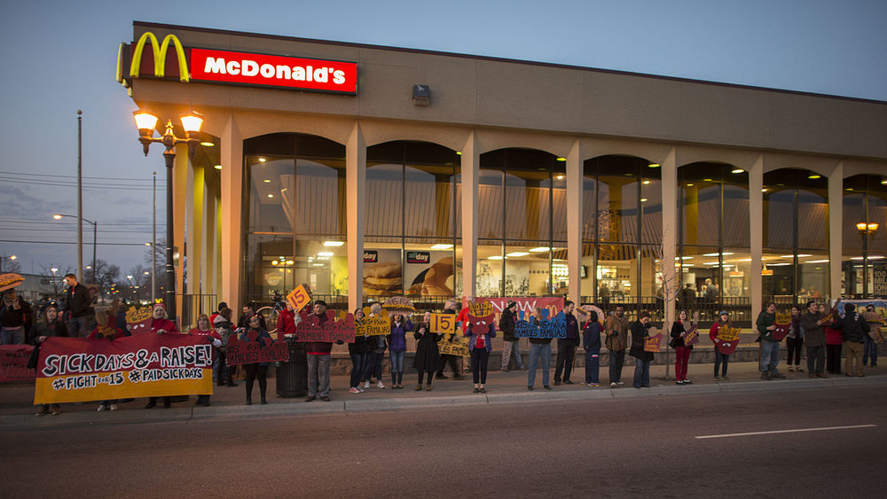  Fast food workers on strike for higher minimum wage and better benefits.&nbsp;   Source  