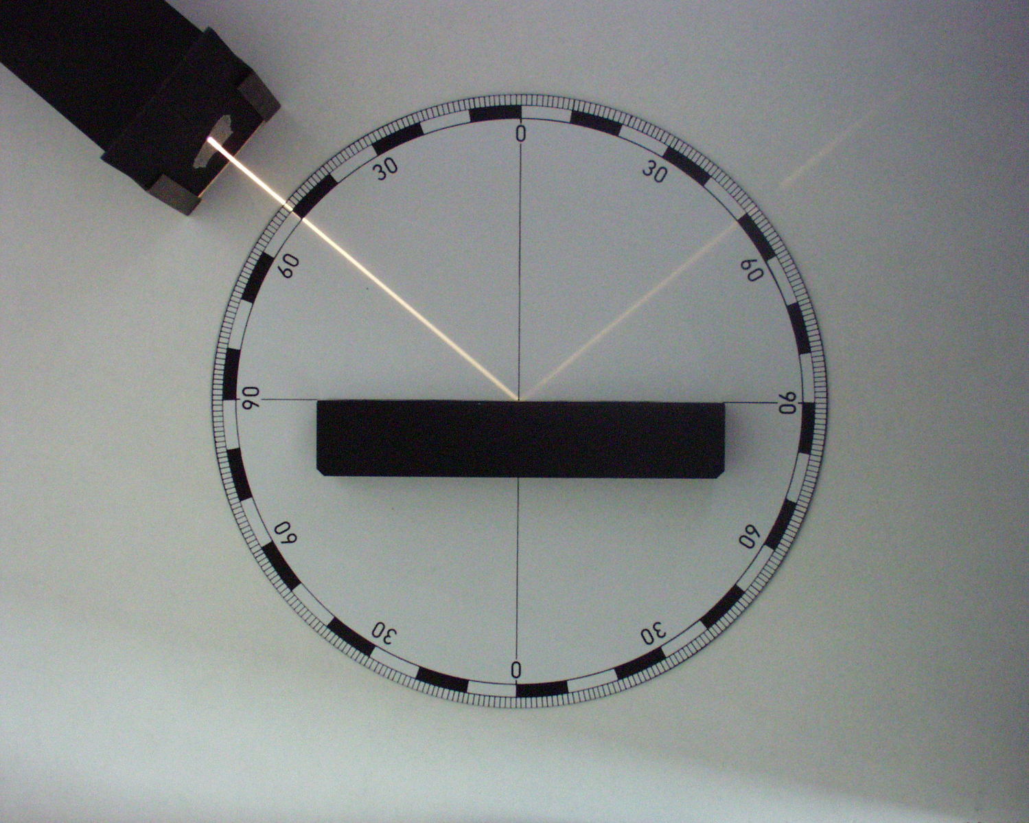 A partial reflective surface, reflecting light but at a weaker intensity than the incoming beam. Image credit: wikimedia user Zátonyi Sándor, CC BY A-SA 3.0