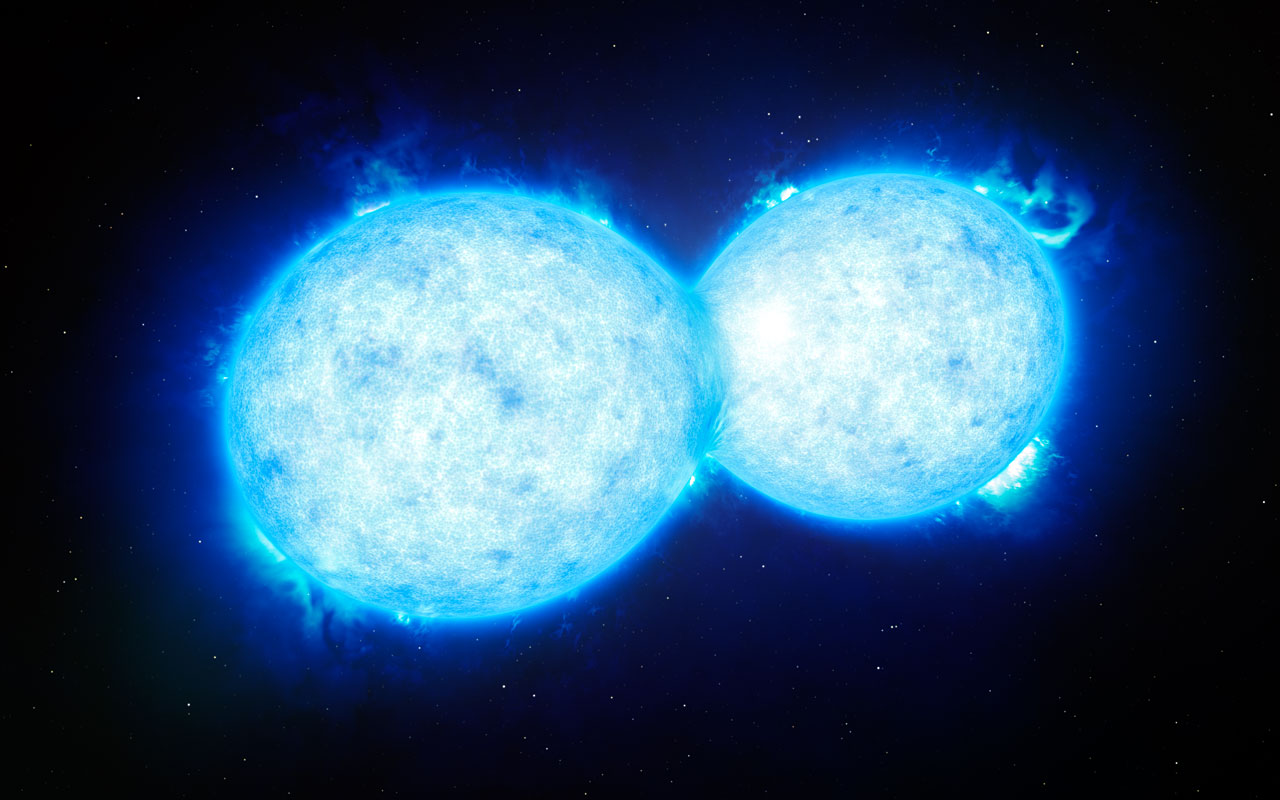This artist’s impression shows VFTS 352 — the hottest and most massive double star system to date where the two components are in contact and sharing material. The two stars in this extreme system lie about 160 000 light-years from Earth in the Large Magellanic Cloud. This intriguing system could be heading for a dramatic end, either with the formation of a single giant star or as a future binary black hole. Image credit: ESO/L. Calçada