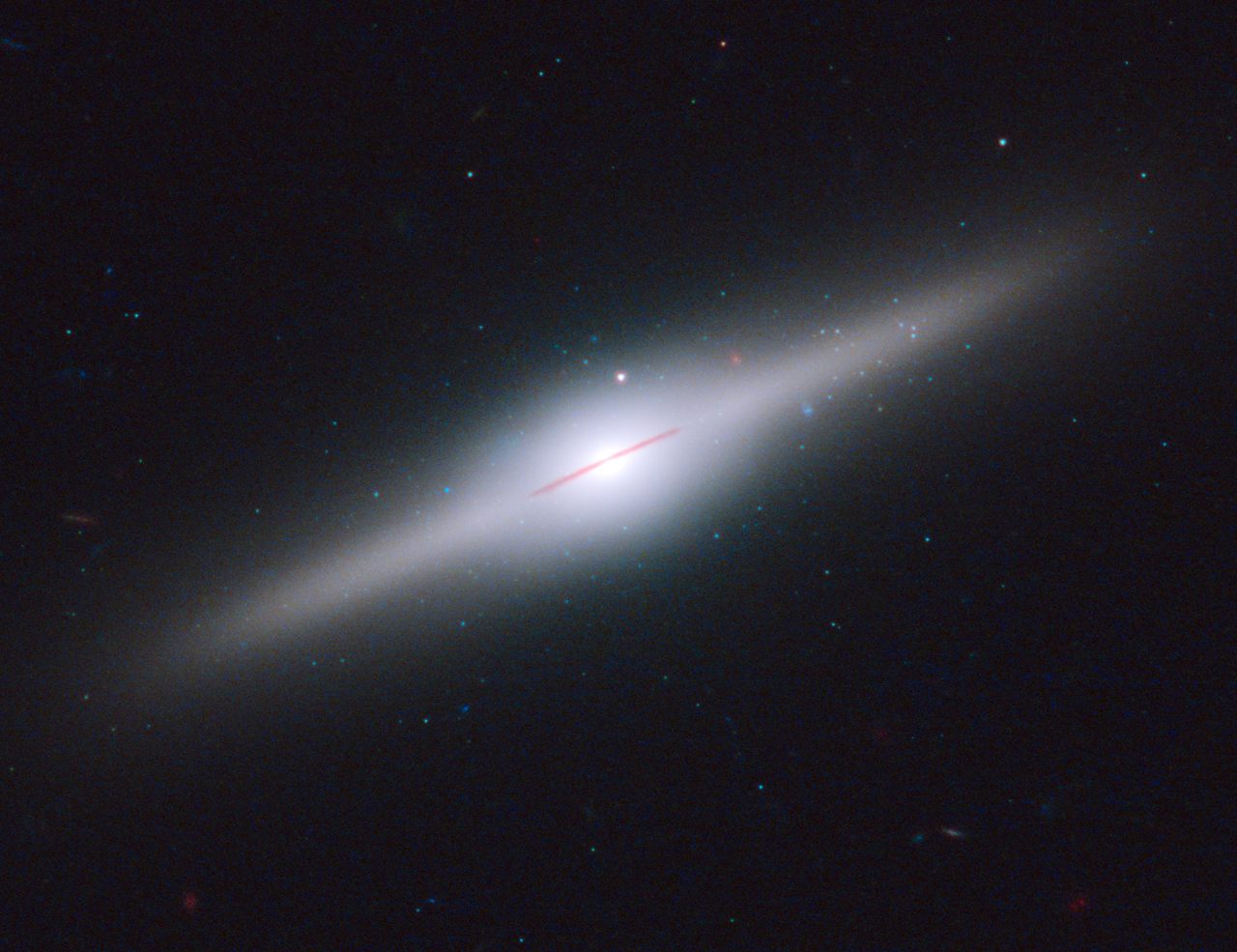 This spectacular edge-on galaxy, called ESO 243-49, is believed to be home to an intermediate-mass black hole that may have been stripped off of a cannibalized dwarf galaxy. The galaxy is 290 million light-years from Earth. Image Credit: NASA, ESA, and S. Farrell (Sydney Institute for Astronomy, University of Sydney)