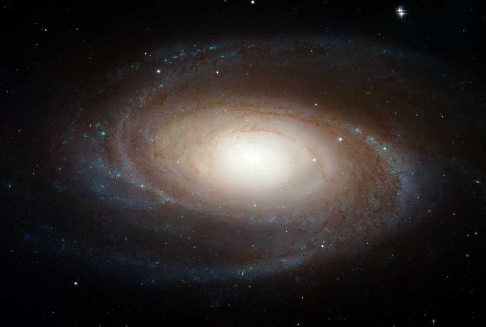 M81 is one of the brightest galaxies that can be seen from the Earth. It is high in the northern sky in the circumpolar constellation Ursa Major, the Great Bear. At an apparent magnitude of 6.8 it is just at the limit of naked-eye visibility. The galaxy's angular size is about the same as that of the Full Moon. The Hubble data was taken with the Advanced Camera for Surveys in 2004 through 2006. This color composite was assembled from images taken in blue, visible, and infrared light. Image Credit: NASA, ESA, and The Hubble Heritage Team (STScI/AURA)