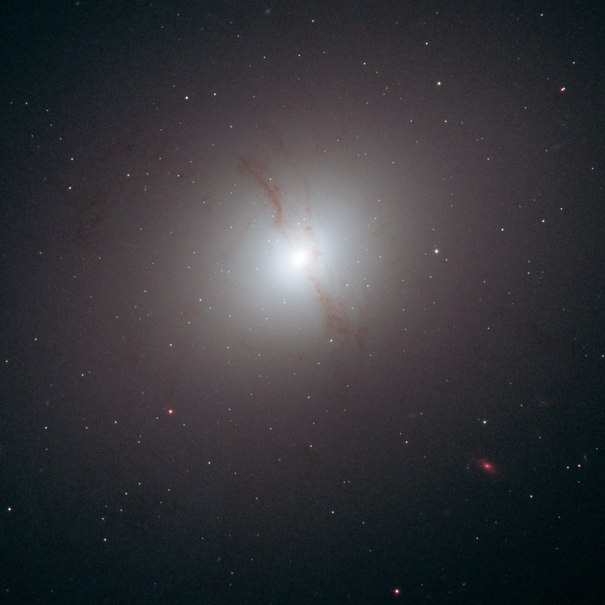 The elliptical galaxy NGC 4589. A dust lane is visible going vertically through the cloud of stars that make up this galaxy. Image Credit: NASA, ESA, and R. Foley (University of Illinois)