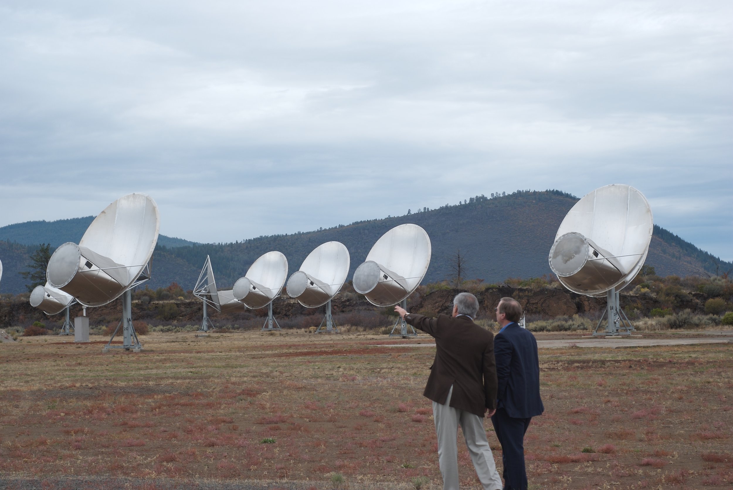 Front view of antennas of the Allan Telescope Array, a radio telescope for combined radio astronomy and SETI (search for extraterrestrial intelligence) research being built by the University of California at Berkeley, outside San Francisco. The first phase, consisting of 42 6-meter dish antennas shown here, was completed in 2007. Eventually it will have 350 antennas. This type of antenna is called an offset Gregorian design. The incoming radio waves are reflected by the large parabolic dish onto a secondary parabolic reflector in front of the dish, and then into a feed horn. A metal shroud along the bottom of the secondary reflector shields the antenna from ground noise. It covers the frequency range from 0.5 to 11.2 GHz. Image credit: Colby Gutierrez-Kraybill, CC BY 2.0