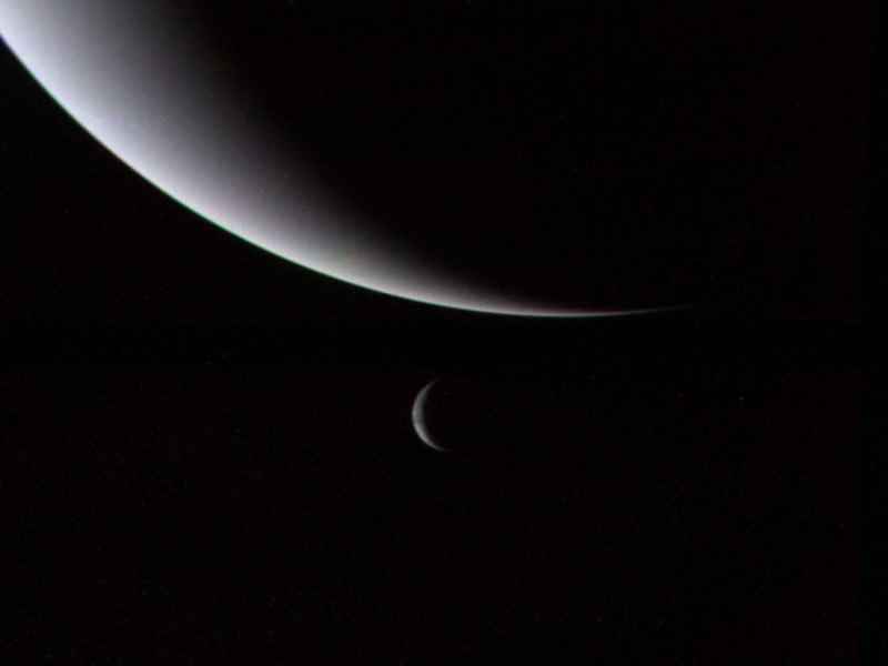 This dramatic view of the crescents of Neptune and Triton was acquired by Voyager 2 approximately 3 days, 6 and one-half hours after its closest approach to Neptune (north is to the right). The spacecraft is now plunging southward at an angle of 48 degrees to the plane of the ecliptic. This direction, combined with the current season of southern summer in the Neptune system, gives this picture its unique geometry. Image credit: NASA/JPL