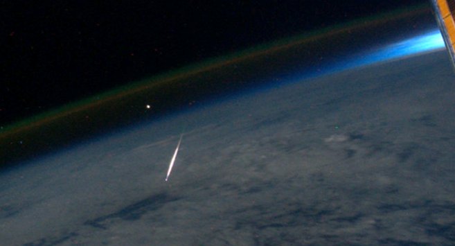 A Perseid meteor lights up as it streaks through the Earth's atmosphere, as seen and photographed by Ron Garan while aboard the International Space Station on August 13, 2011. Image credit: NASA