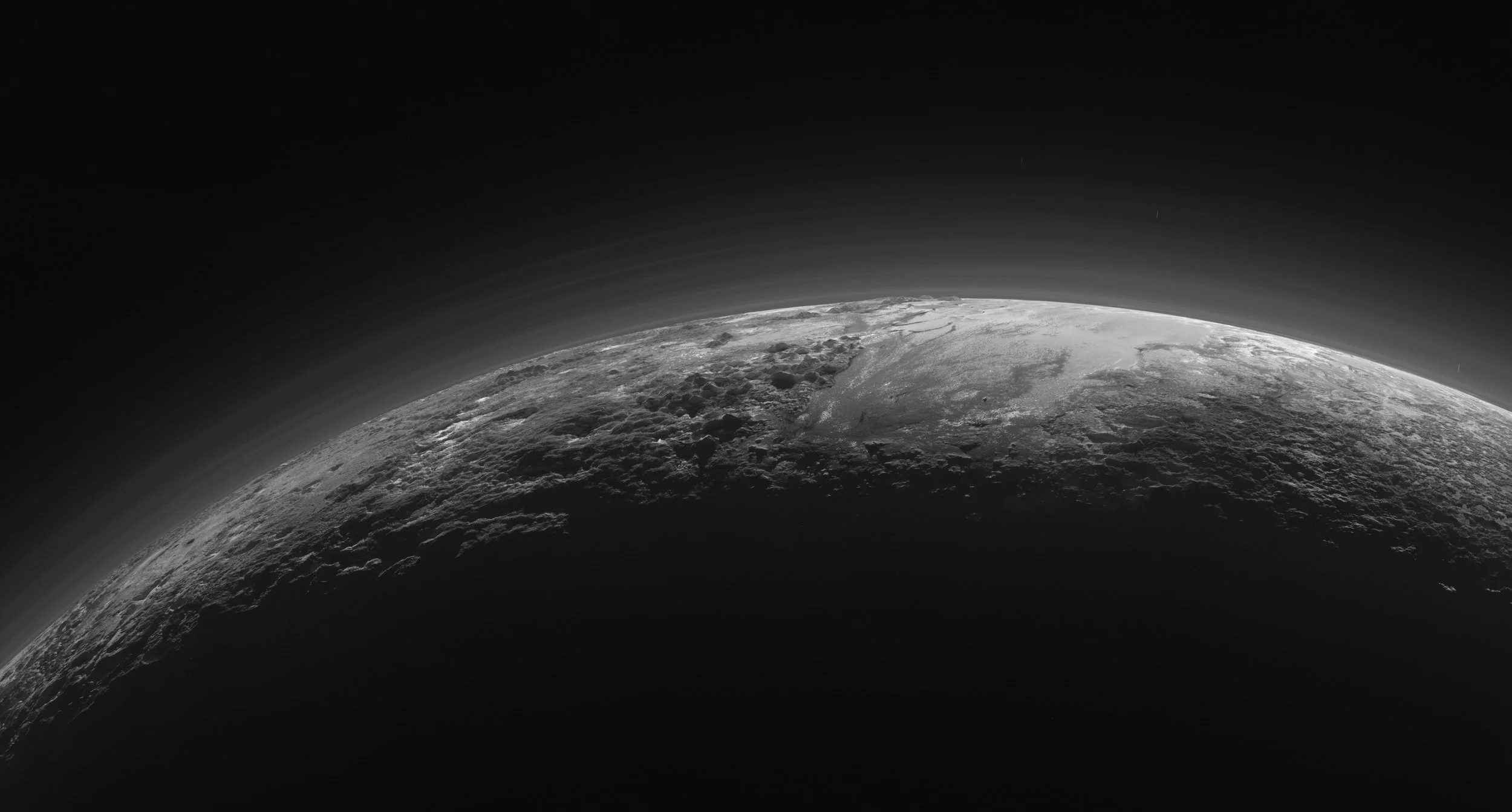 Plutonian landscapes in twilight, under a hazy sky. Credit: NASA/JHU APL/SwRI