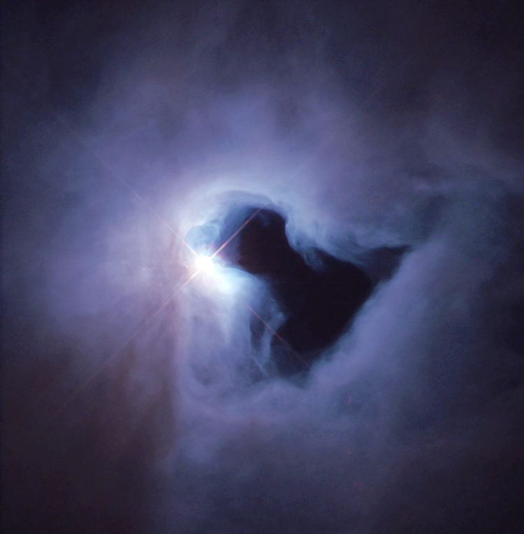 NGC 1999 is an example of a reflection nebula. Like fog around a street lamp, a reflection nebula shines only because the light from an embedded source illuminates its dust; the nebula does not emit any visible light of its own. NGC 1999 lies close to the famous Orion Nebula, about 1,500 light-years from Earth, in a region of our Milky Way galaxy where new stars are being formed actively. Image Credit: NASA and The Hubble Heritage Team (STScI)