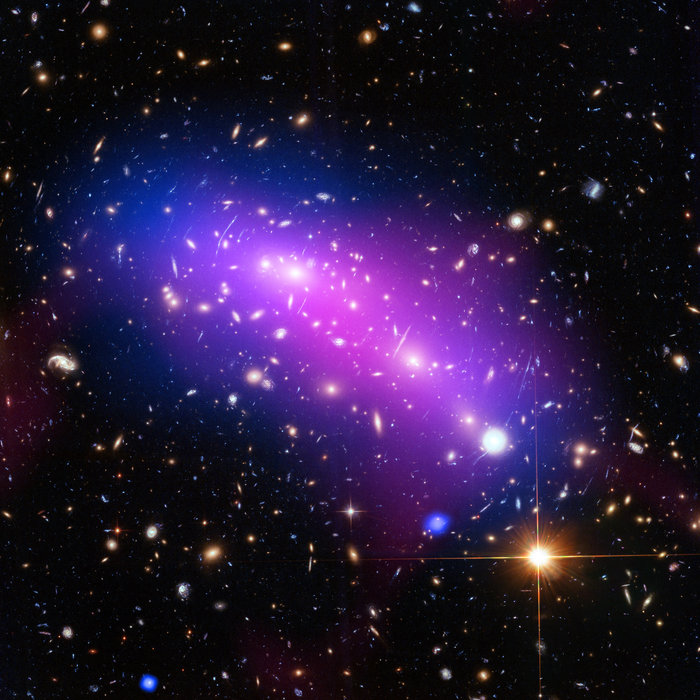 At first glance, this cosmic kaleidoscope of purple, blue and pink offers a strikingly beautiful — and serene — snapshot of the cosmos. However, this multi-coloured haze actually marks the site of two colliding galaxy clusters, forming a single object known as MACS J0416.1-2403 (or MACS J0416 for short). Image credit: NASA, ESA, CXC, NRAO/AUI/NSF, STScI, and G. Ogrean (Stanford University)
