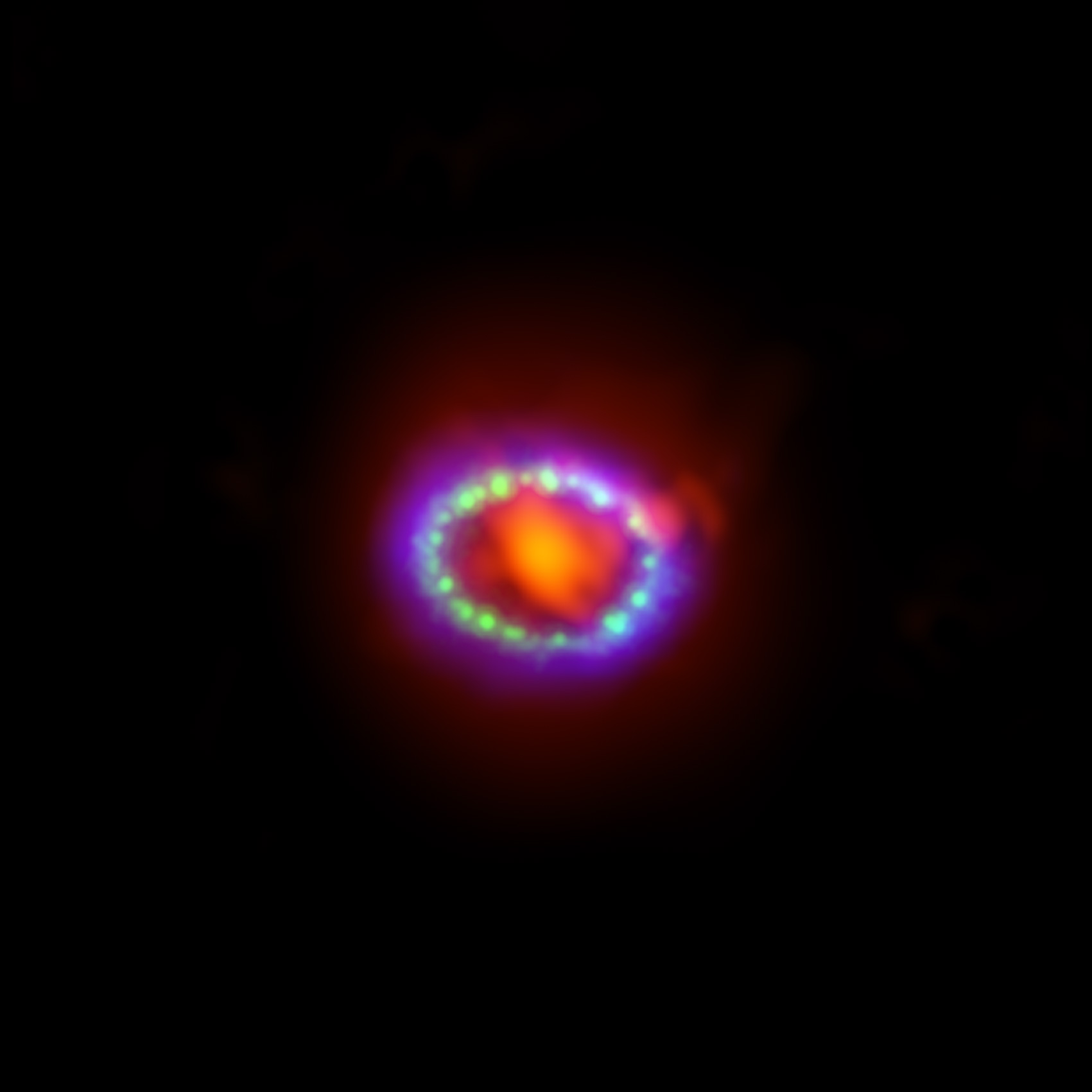 This image shows the remnant of Supernova 1987A seen in light of very different wavelengths. ALMA data (in red) shows newly formed dust in the centre of the remnant. Hubble (in green) and Chandra (in blue) data show the expanding shock wave. Image credit: ALMA (ESO/NAOJ/NRAO)/A. Angelich. Visible light image: the NASA/ESA Hubble Space Telescope. X-Ray image: The NASA Chandra X-Ray Observatory