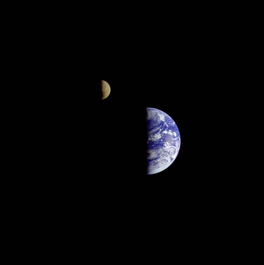 The Galileo spacecraft took this 1992 shot showing the Moon in orbit about Earth. With only a third of the brightness of Earth, the Moon has been digitally enhanced to improve visibility. Image credit: NASA