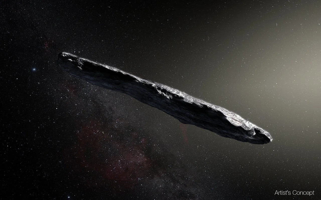 This artist’s impression shows the first interstellar asteroid: `Oumuamua. This unique object was discovered on 19 October 2017 by the Pan-STARRS 1 telescope in Hawai`i. Subsequent observations from ESO’s Very Large Telescope in Chile and other observatories around the world show that it was traveling through space for millions of years before its chance encounter with our star system. Image credit: European Southern Observatory/M. Kornmesser