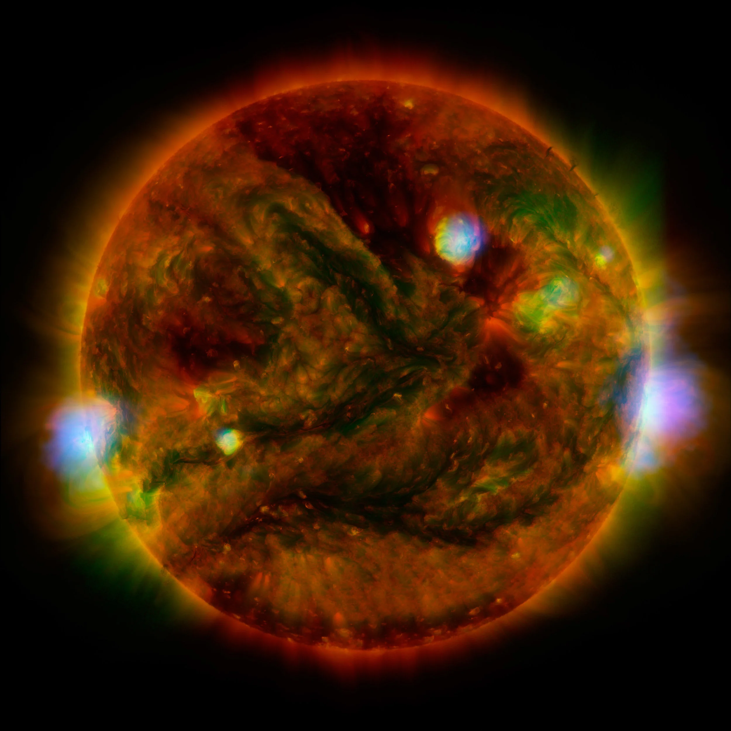 Flaring, active regions of our sun are highlighted in this new image combining observations from several telescopes. High-energy X-rays from NASA's Nuclear Spectroscopic Telescope Array (NuSTAR) are shown in blue; low-energy X-rays from Japan's Hinode spacecraft are green; and extreme ultraviolet light from NASA's Solar Dynamics Observatory (SDO) is yellow and red. Image credit: NASA/JPL-Caltech/GSFC/JAXA