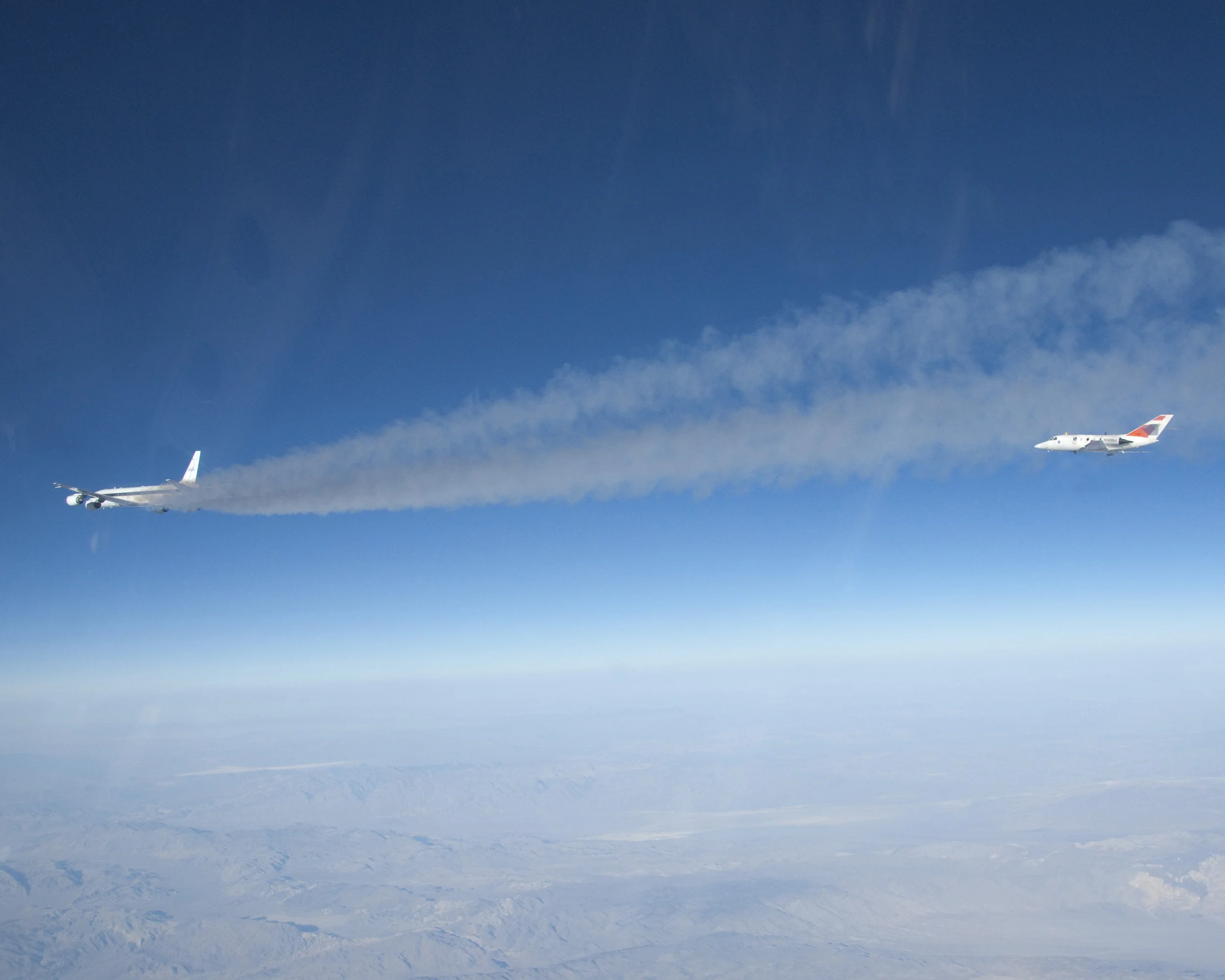 Flying some 500 feet behind NASA's DC-8 flying laboratory, NASA Langley's heavily instrumented HU-25 Falcon measured chemical components of the exhaust streaming from the DC-8's engines burning a 50/50 mix of conventional jet fuel and a plant-based biofuel during the 2013 ACCESS biofuels flight tests. Image credit: NASA/Lori Losey