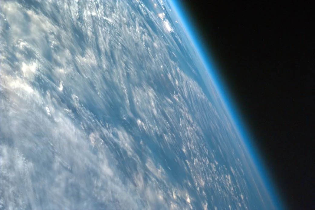 Most ISS images are nadir, in which the center point of the image is directly beneath the lens of the camera, but this one is not. This highly oblique image of northwestern African captures the curvature of the Earth and shows its atmosphere. Image credit: NASA/JPL/UCSD/JSC