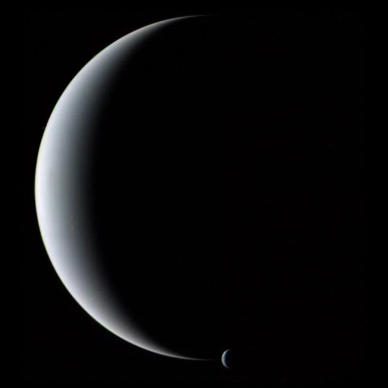 Crescent Neptune and Triton. Image credit: Voyager 2, NASA