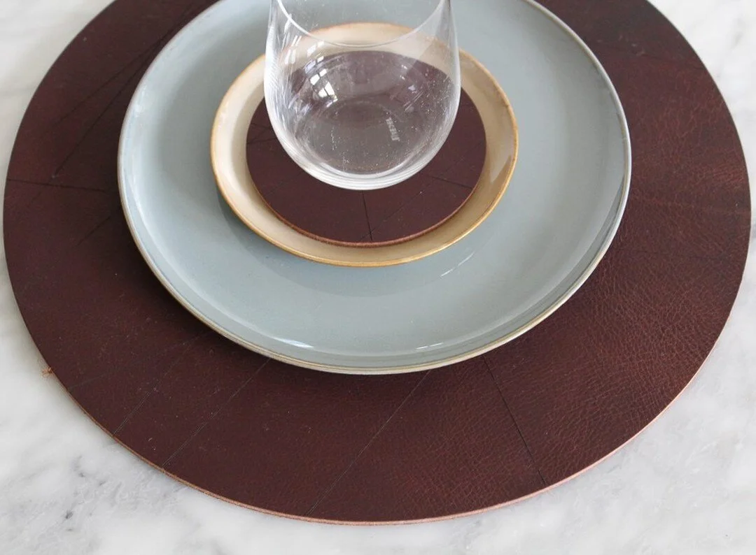 Our Modern Lines placemats, coasters, and napkin rings started off as Christmas gifts for our families. The elegant lines and 100% leather pair beautifully with and instantly upgrade a variety of place settings. Now that we've aded them to our online