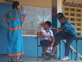 Youth and Peace Corps Volunteers discuss notes after rehearsal