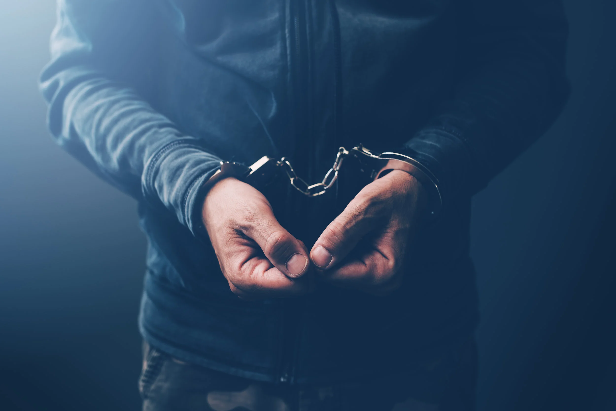 arrested-computer-hacker-with-handcuffs-PNMQUBG.jpg