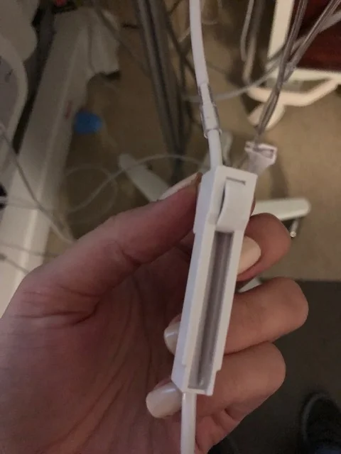 The clamp - somewhat of a moot point if there is a channel above it, but if a bolus is running this helps dictate the flow. Move it down to clamp it (slower flow) and move it up to open it up (faster flow)