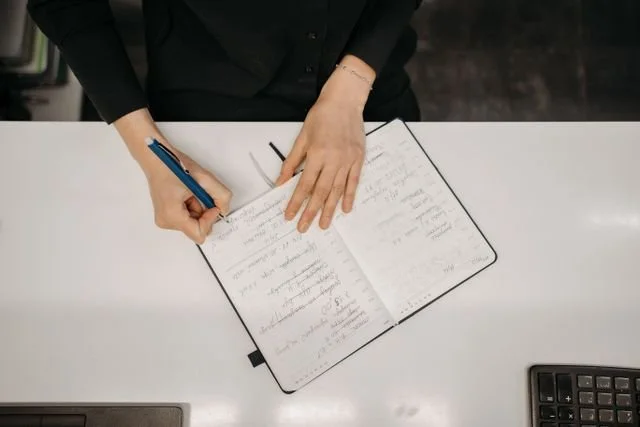 Women writing in a note book