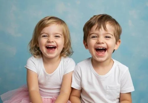 two-happy-young-children-a-boy-and-a-girl-laughing-together-in-a-studio-free-photo.jpeg