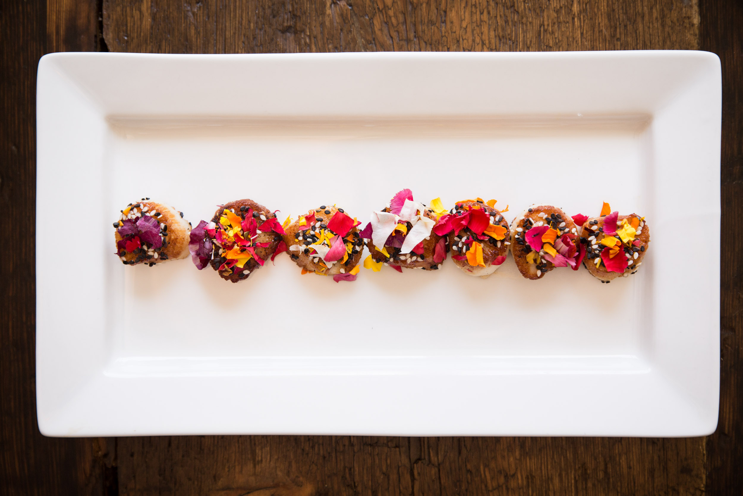 Sesame-Seared Scallop with Blueberry Gastrique and Edible Flowers