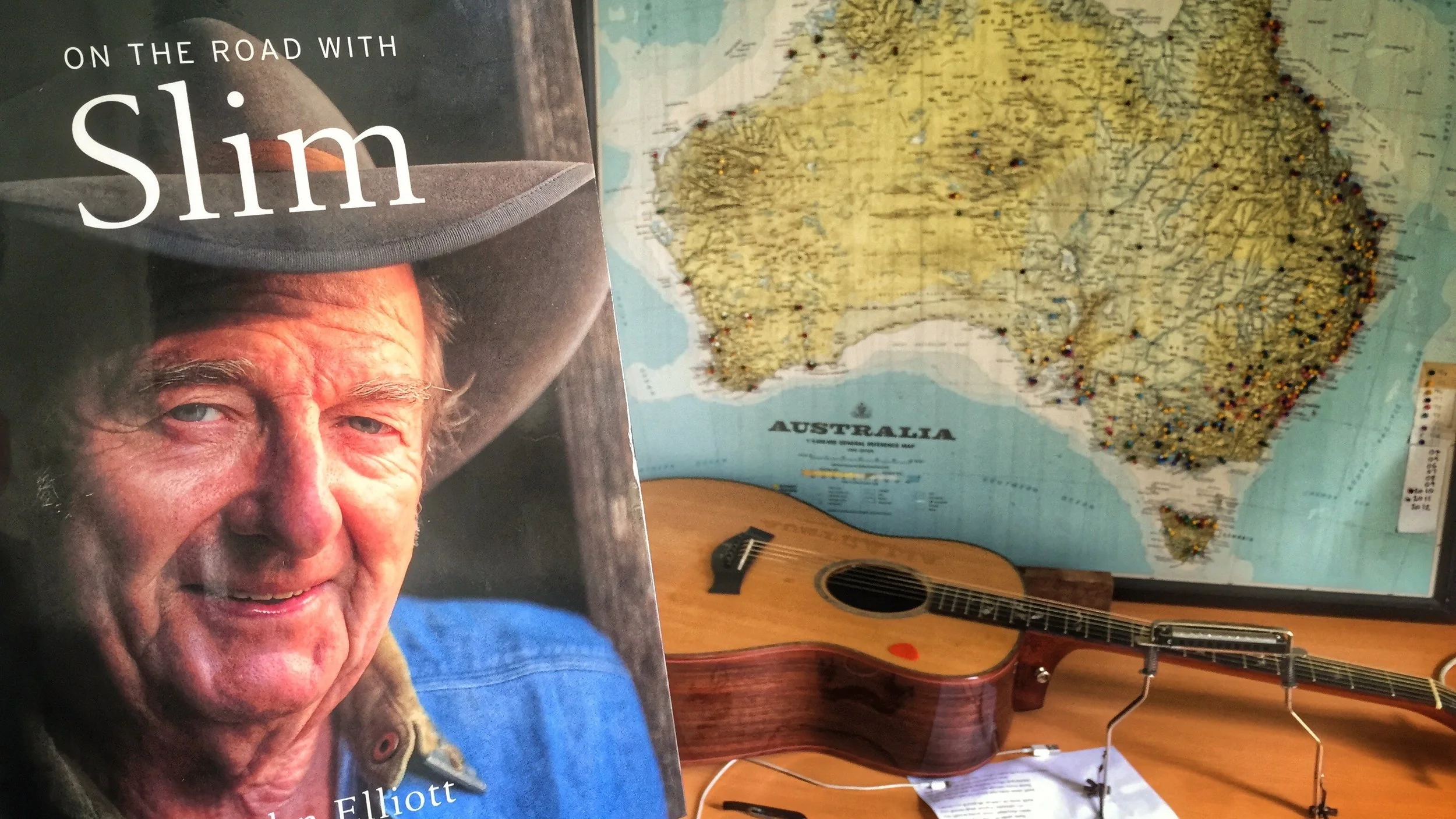 Pictured: The legendary Slim Dusty and a map of his beloved country.