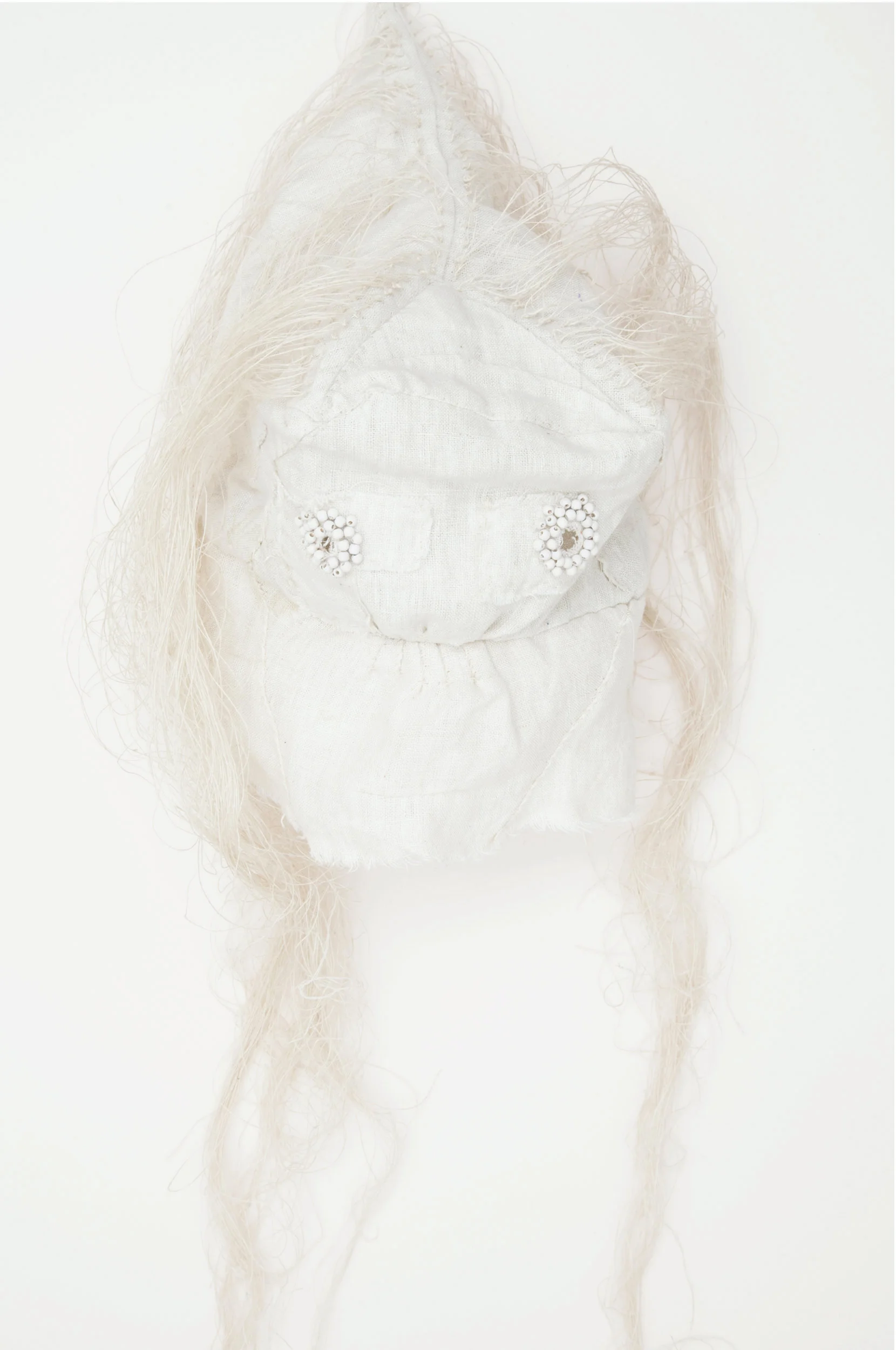 Mask (white) / 2015 from the serie “Apotropäen” textiles and div. materials 25 x 25 x 70cm