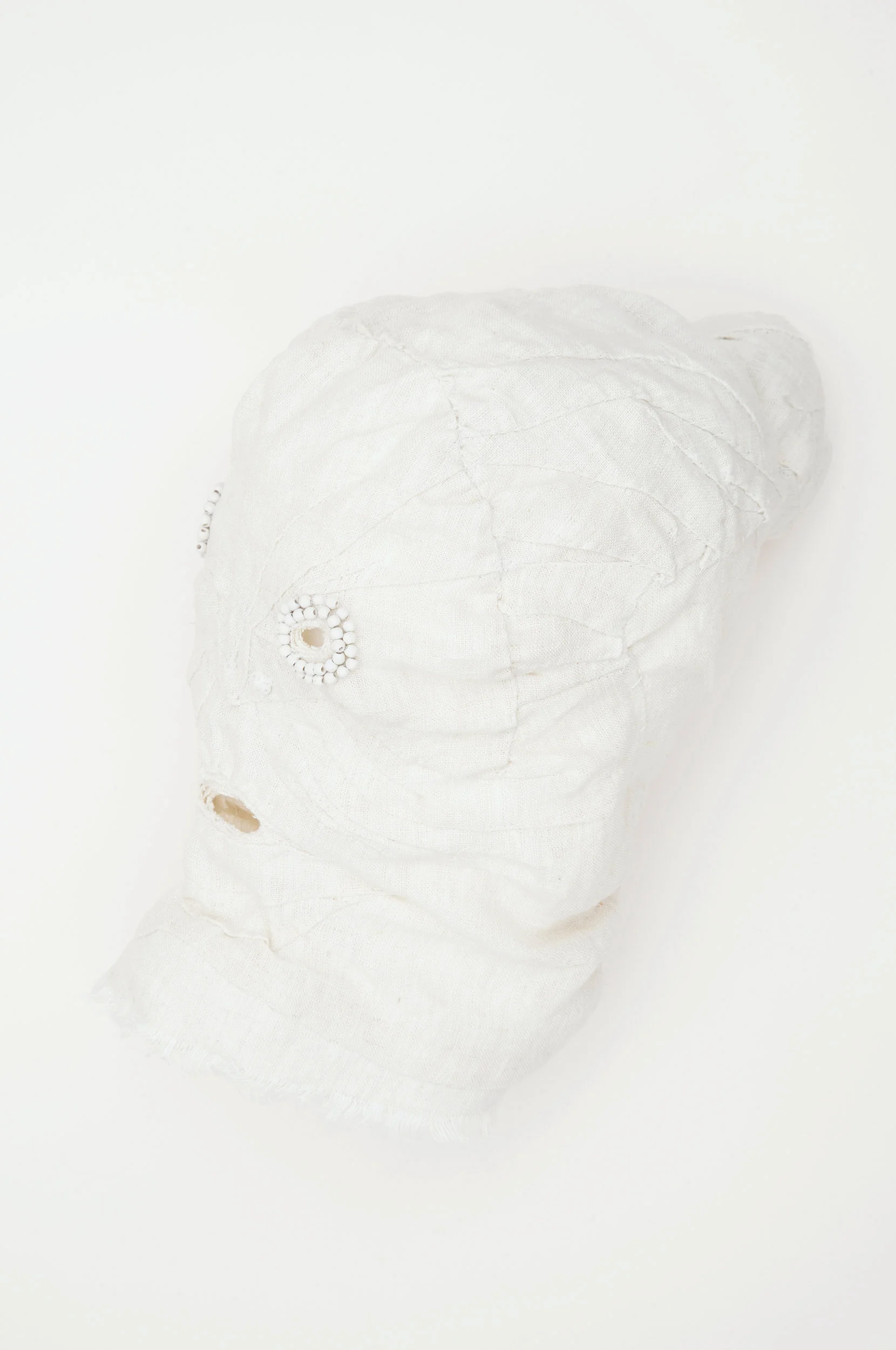 Mask (white) / 2016 from the serie “Apotropäen” textiles and div. materials 25 x 25 x 30cm