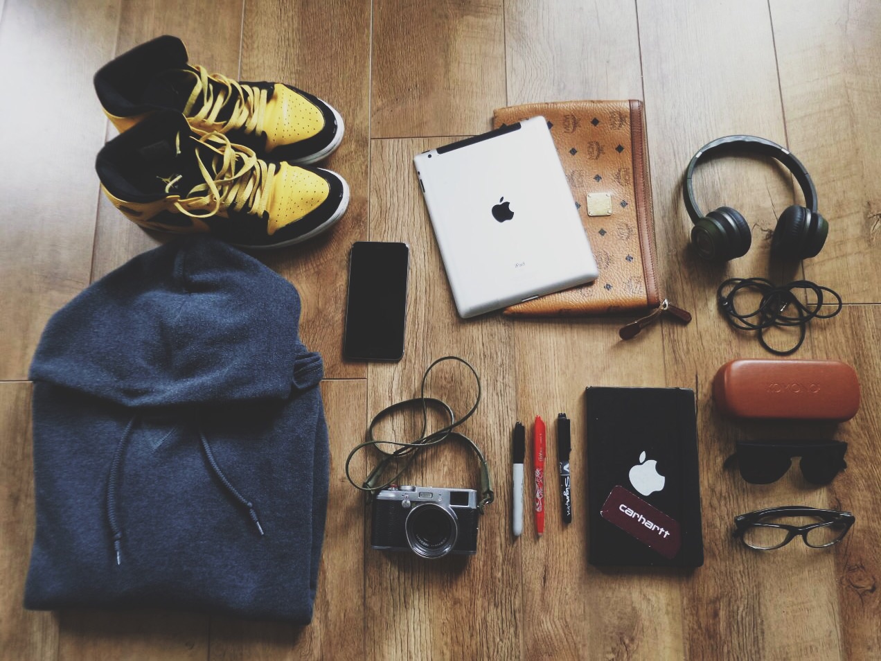 Kicks : Air Jordan 1 ; Grey Hoodie : Russell Athletics (Beware a guy that doesn't wear one ahah) ; My Ipad and his MCM pouch ; Monster Headphones ; Of course my Iphone 6s Plus (My mobile office) ; Fuji X100 : My point and shoot camera follow me everywhere (needs an update tho), Pilot ball Frixion, Sharpie Fine point, Pilot sign point, they are my pens ; My moleskine (3 years following me this one) ; Komono sunglasses and YSL glasses. 