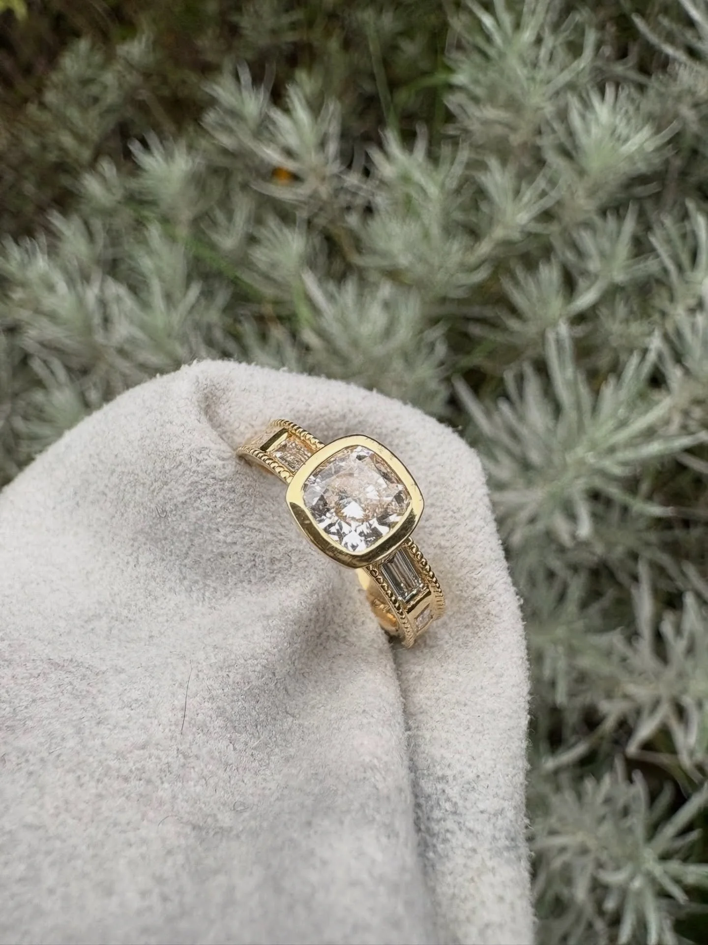 Can we please take a moment for this showstopper of a ring!

A bold cushion-cut centre stone set in 18ct Fairmined gold, and flanked by baguette diamonds with milgrain detailing. Every angle and detail was carefully considered throughout this design,