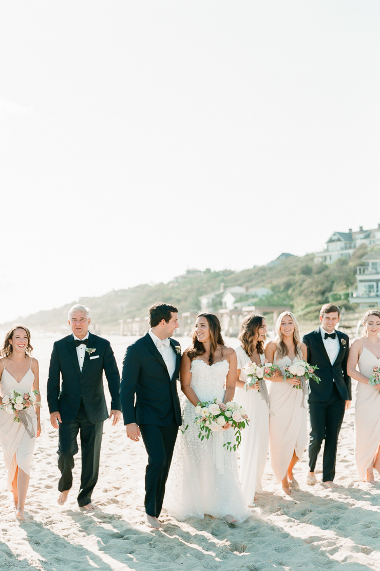 Bride and Groom walking on Beach with Bridal Party in Montauk, NY