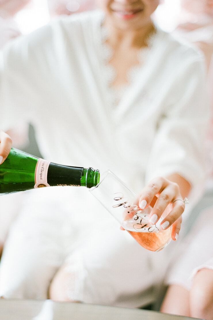 Bride Pouring Champagne on Wedding Day