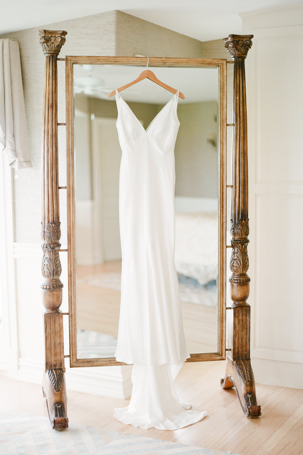 Brides Dress Hanging on Mirror in Bridal Suite