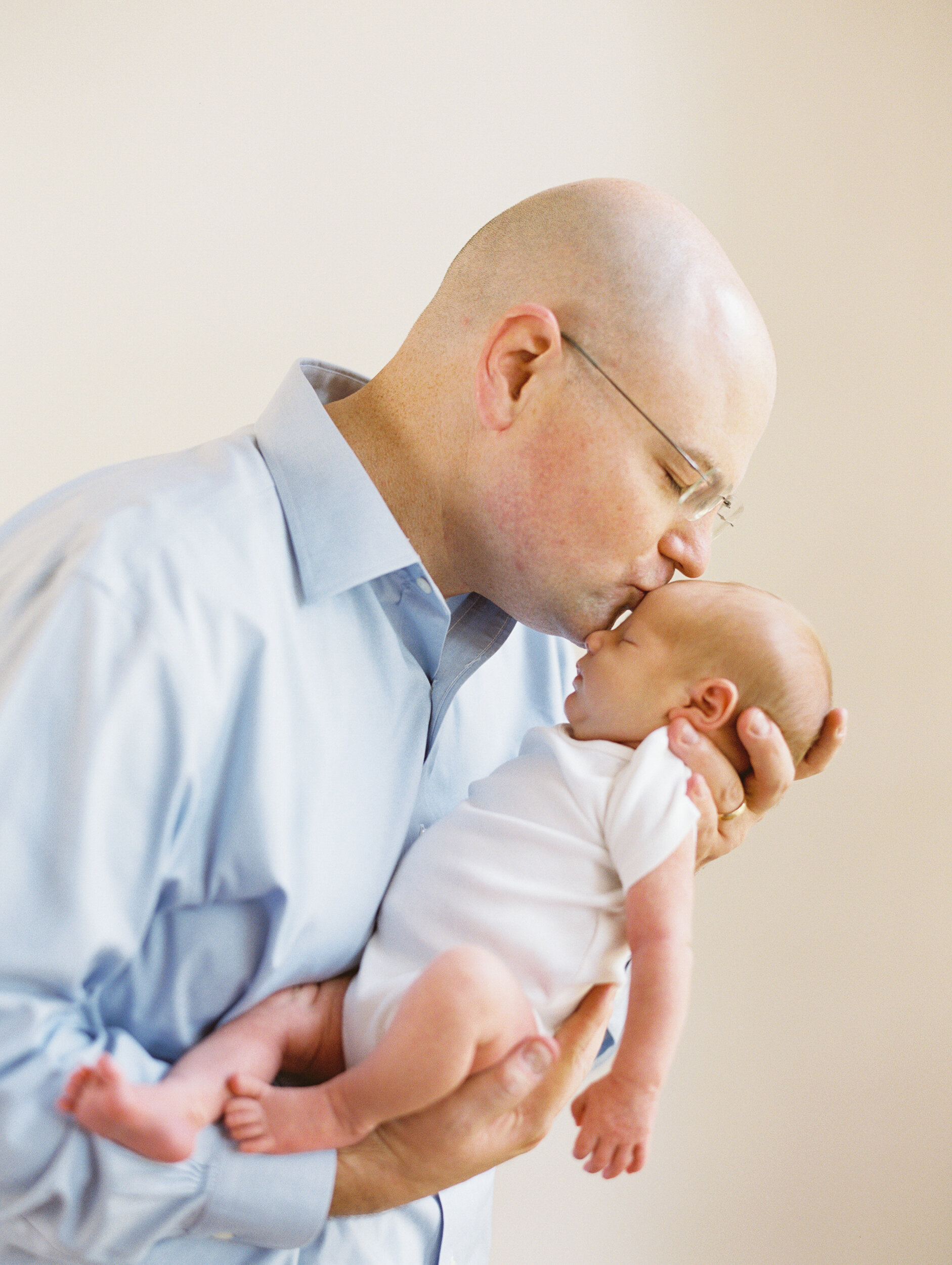 Dad Kissing Newborn Son